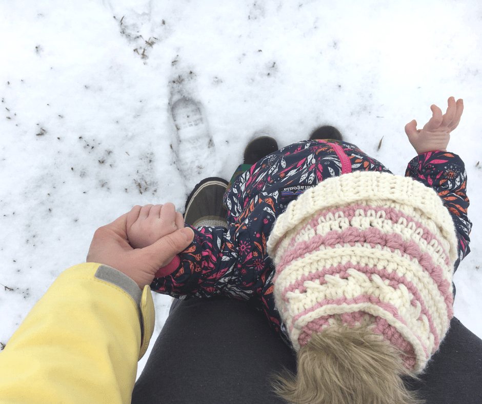 mom and daughter holding hands while wearing the dandelion beanie crochet pattern